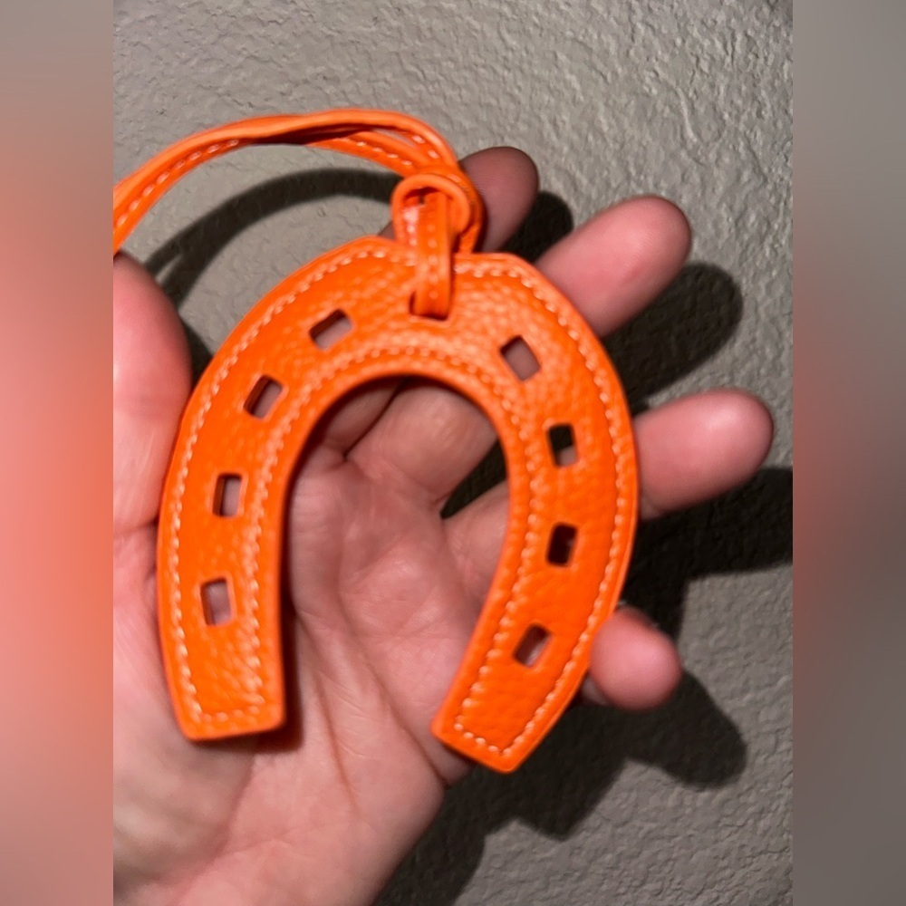Celebrity look horseshoe purse charms in faux leather orange with white thread